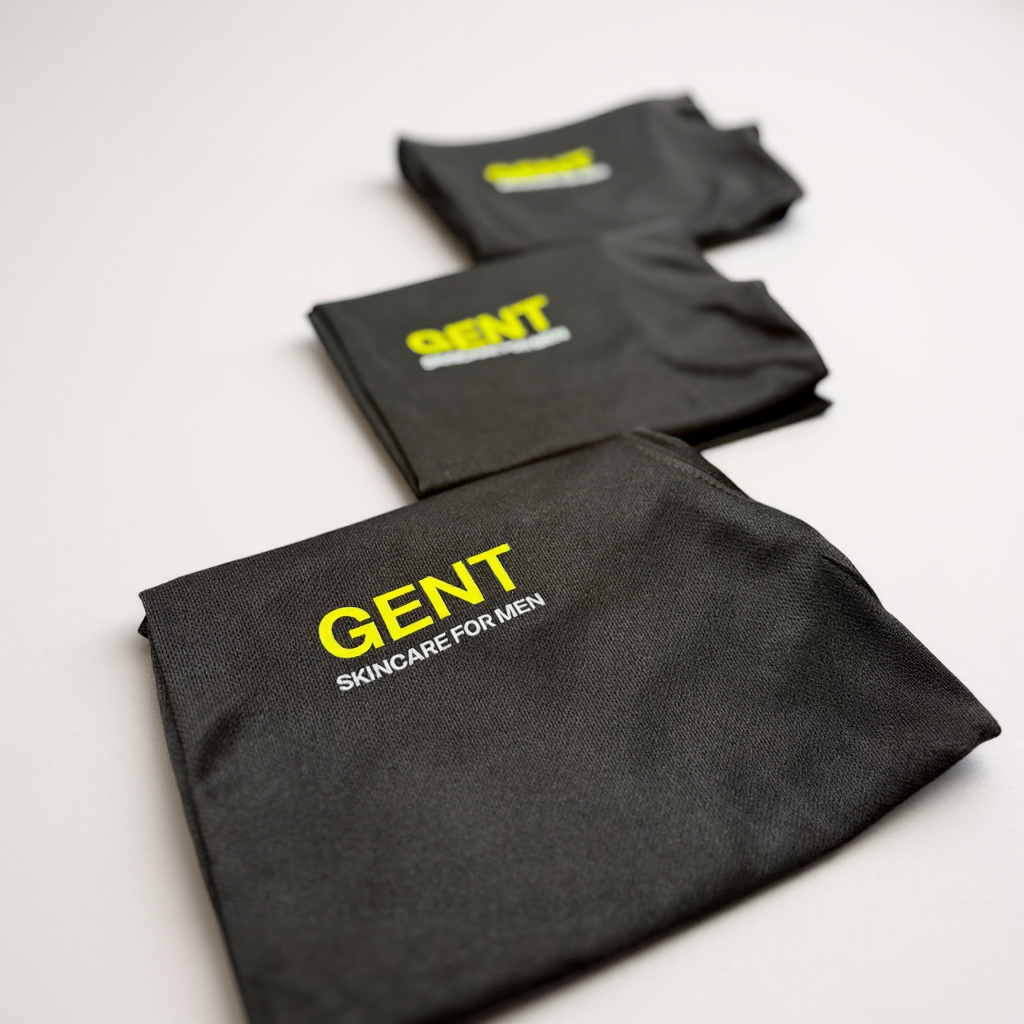 Black company t-shirts with 'GENT' branding on a light grey background