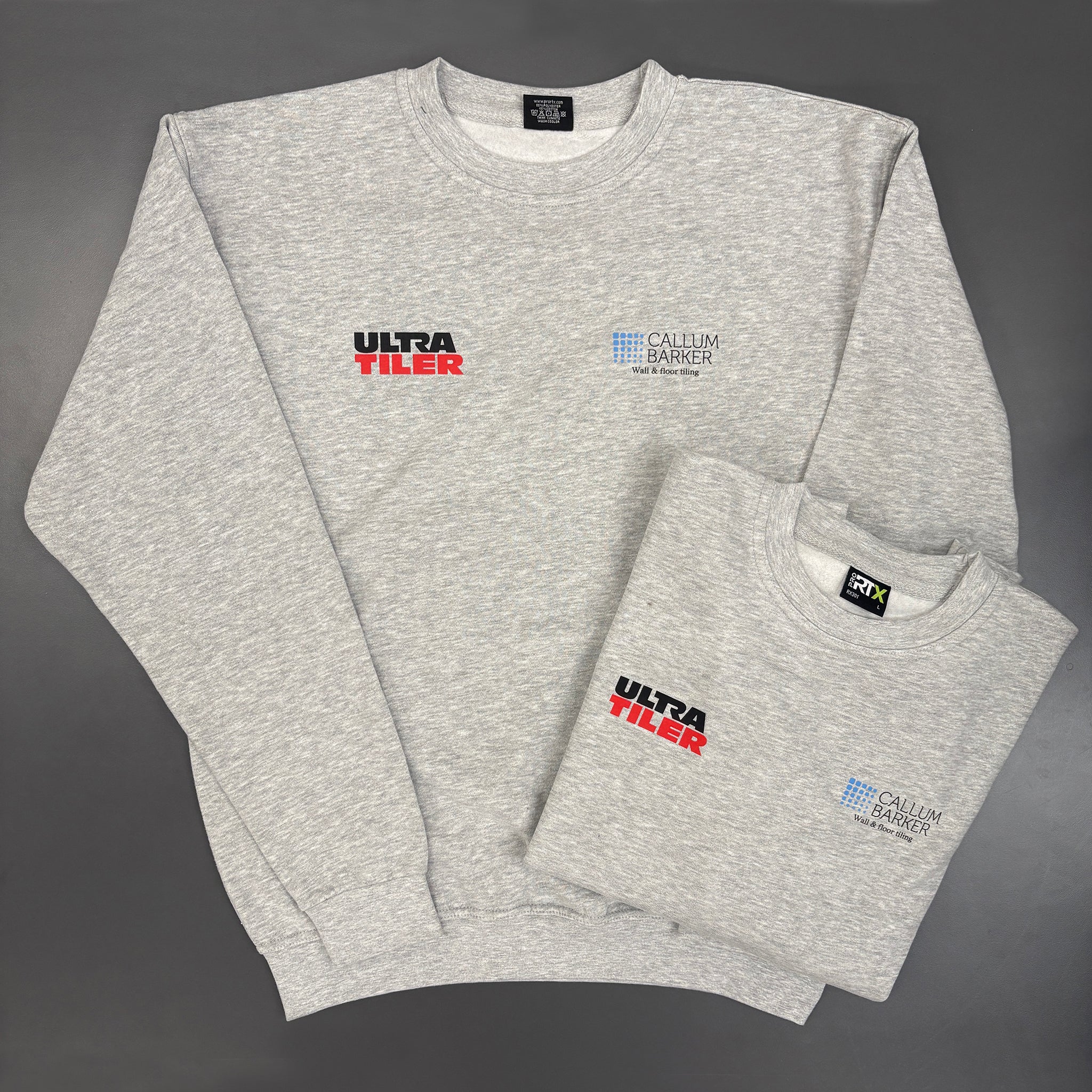 Grey sweatshirt printed with brand logos on a grey background